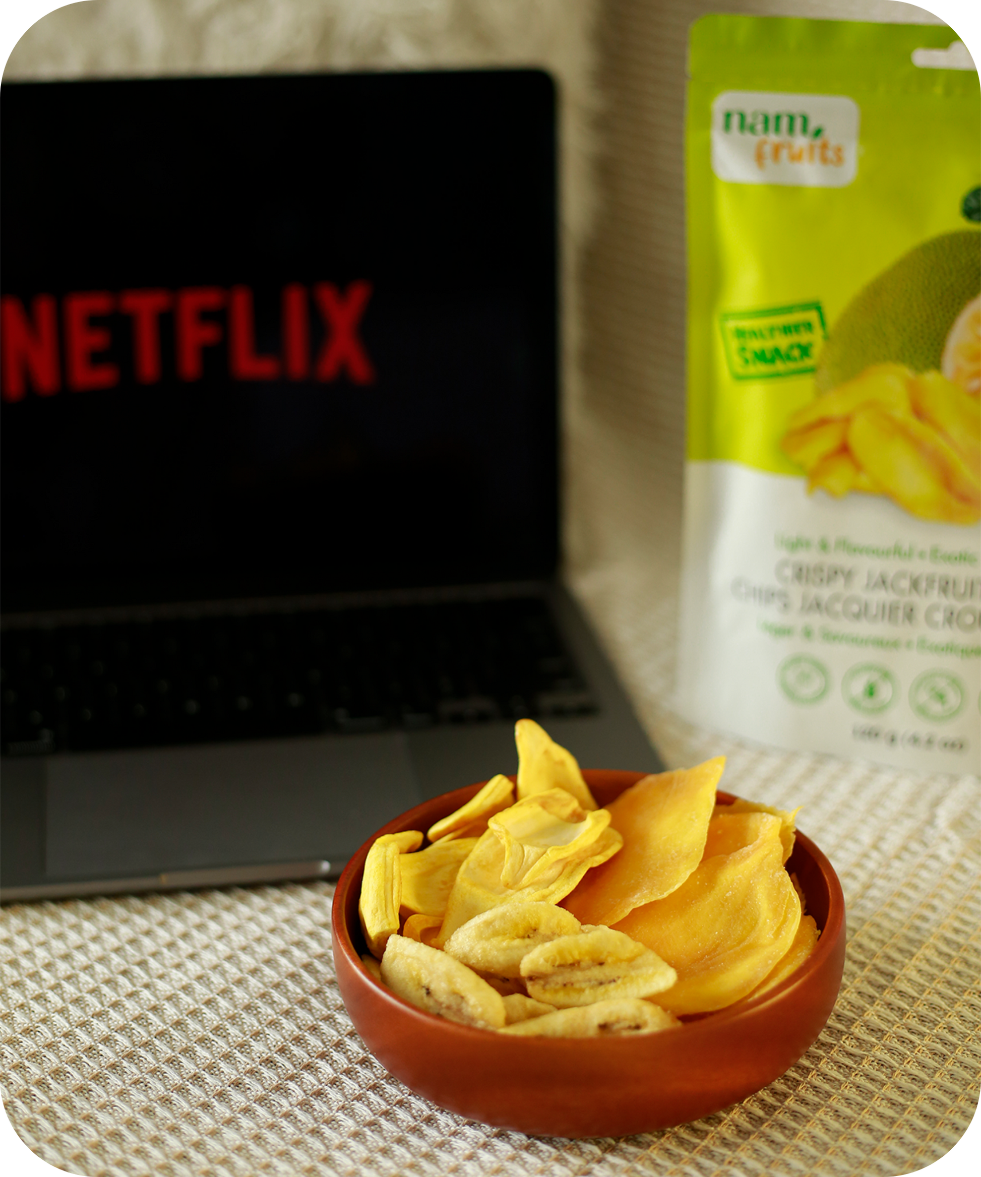 Customer enjoying NamFruits jackfruit, banana, and mango chips while watching Netflix