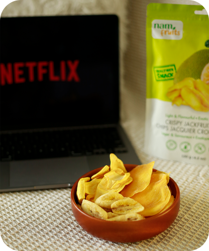 Customer enjoying NamFruits jackfruit, banana, and mango chips while watching Netflix